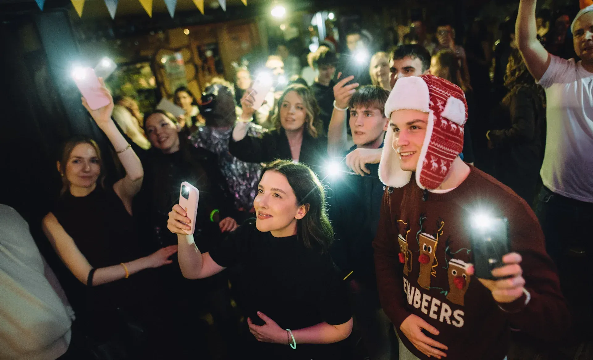 Modsen employees at a corporate party with flashlights